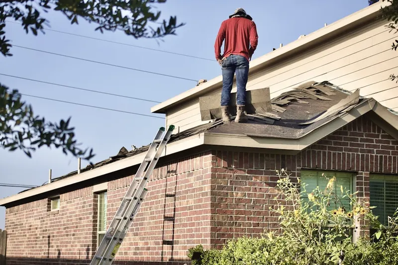 Professional roofer working on a residential roof in Benson